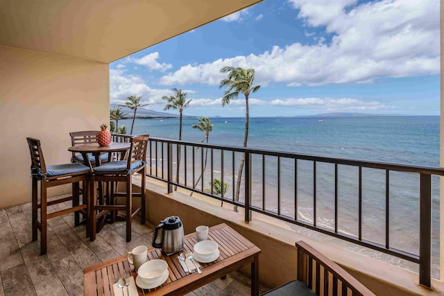 balcony with a view of the beach and a water view