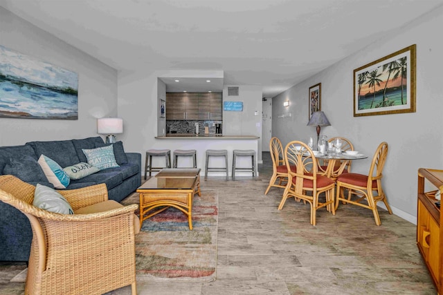 living room featuring wood finished floors and baseboards