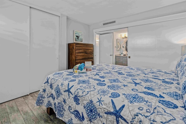 bedroom featuring light hardwood / wood-style floors and a closet