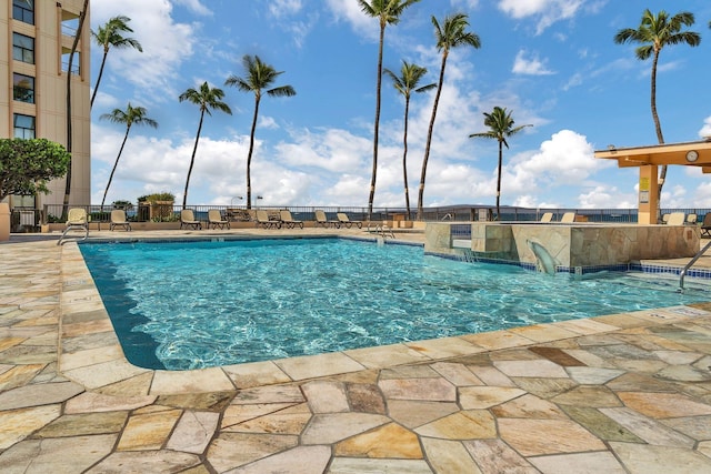 pool with fence and a patio