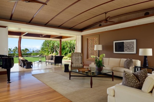 living area featuring vaulted ceiling, wood finished floors, and ceiling fan