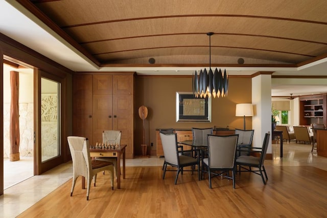 dining area featuring wood ceiling, lofted ceiling, a tray ceiling, ornamental molding, and light wood-style flooring