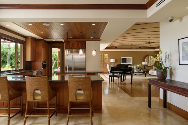 kitchen with visible vents, recessed lighting, a sink, wood ceiling, and built in fridge