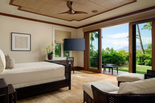 bedroom featuring light wood-style flooring, crown molding, ceiling fan, and access to outside