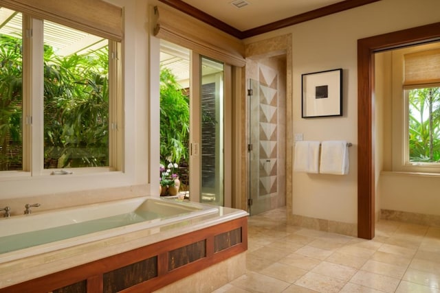 bathroom with a bath, tile patterned floors, a stall shower, and baseboards