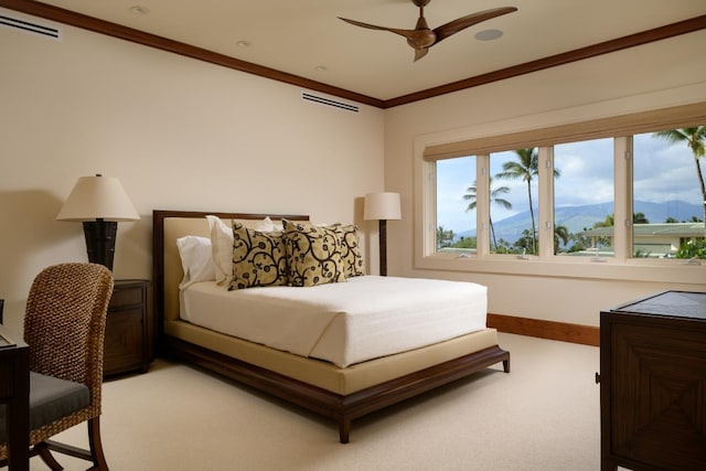 bedroom featuring visible vents, baseboards, crown molding, light colored carpet, and a mountain view