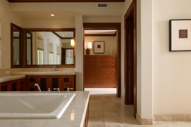 full bathroom featuring tile patterned flooring, a bath, visible vents, and a sink