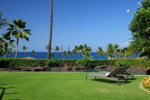 view of community with a yard and a water view