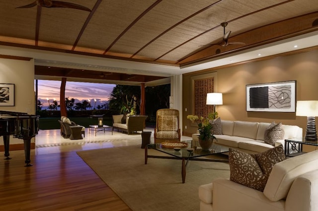 living room with a ceiling fan, lofted ceiling, and wood finished floors