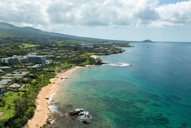 birds eye view of property with a beach view and a water view