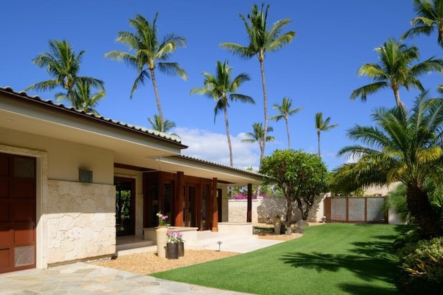 view of yard featuring a garage and fence