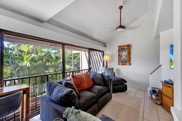 living room featuring lofted ceiling, light tile patterned floors, and ceiling fan