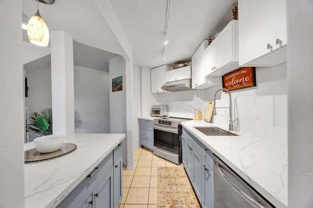 kitchen with pendant lighting, white cabinetry, appliances with stainless steel finishes, and sink