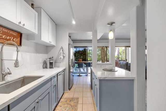 kitchen with sink, gray cabinets, white cabinetry, stainless steel appliances, and decorative light fixtures