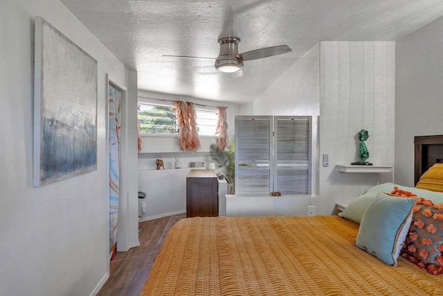 bedroom with ceiling fan, a textured ceiling, and light wood-type flooring