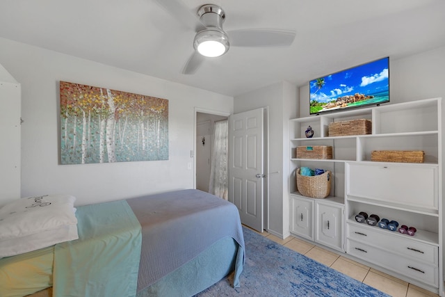 tiled bedroom featuring ceiling fan