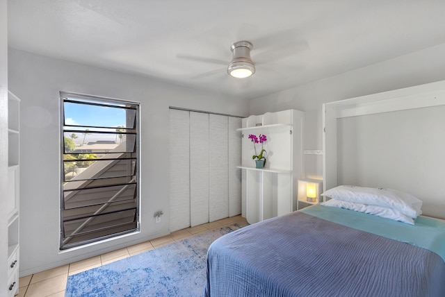 tiled bedroom featuring a closet and ceiling fan