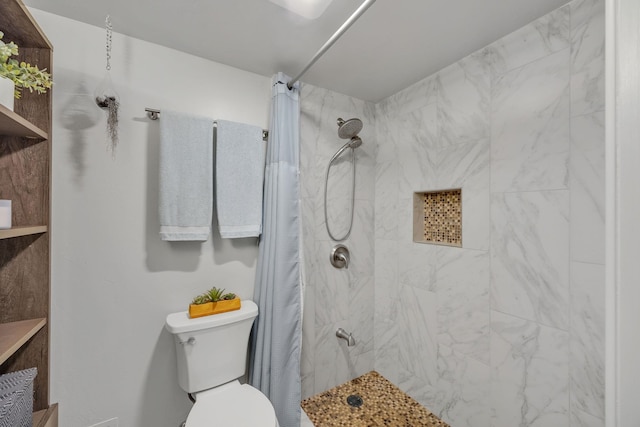 bathroom with a shower with curtain and toilet