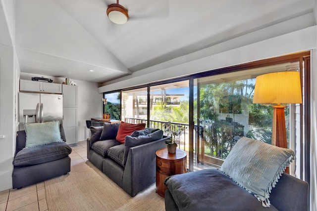 living room featuring lofted ceiling and light tile patterned floors