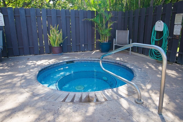 view of swimming pool with a patio area and an in ground hot tub