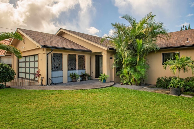 view of front of home with a patio and a front yard