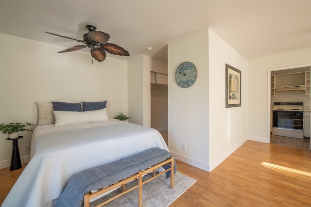 bedroom with a closet, ceiling fan, and light hardwood / wood-style flooring