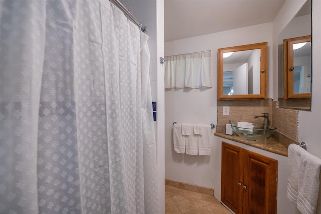 bathroom featuring curtained shower, tasteful backsplash, tile patterned flooring, and vanity