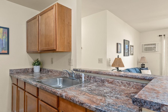 480 Kenolio Rd Unit 21-101, Kihei, HI 96753 - kitchen with a sink, dark countertops, and brown cabinets