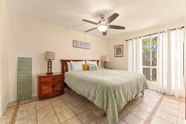 480 Kenolio Rd Unit 21-101, Kihei, HI 96753 - tiled bedroom with baseboards and a ceiling fan