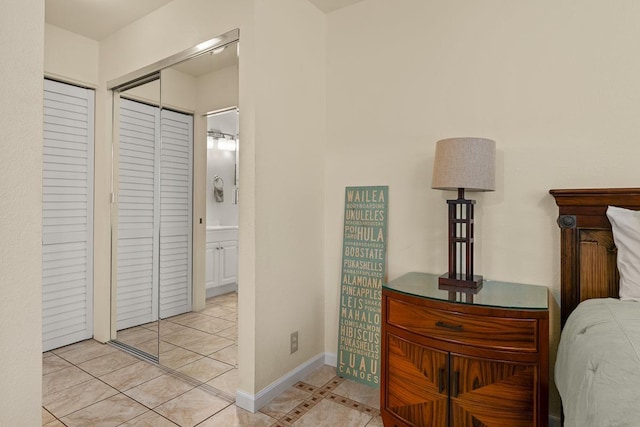 480 Kenolio Rd Unit 21-101, Kihei, HI 96753 - bedroom with tile patterned flooring, baseboards, and ensuite bath