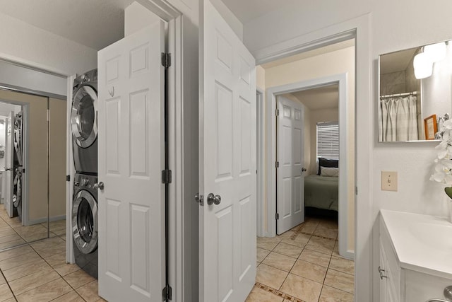 480 Kenolio Rd Unit 21-101, Kihei, HI 96753 - laundry area with stacked washer / dryer and light tile patterned flooring