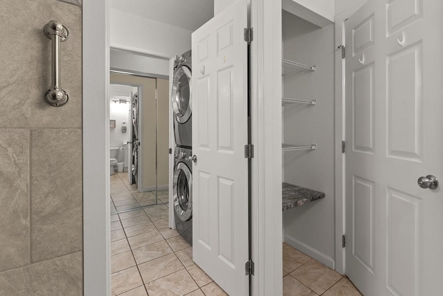 480 Kenolio Rd Unit 21-101, Kihei, HI 96753 - laundry room with estacked washer and dryer, light tile patterned floors, and baseboards