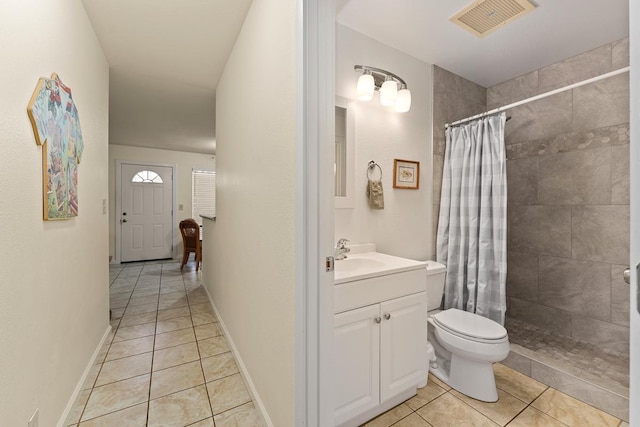 480 Kenolio Rd Unit 21-101, Kihei, HI 96753 - bathroom with tile patterned flooring, vanity, tiled shower, and toilet