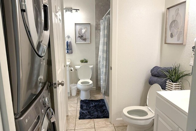 480 Kenolio Rd Unit 21-101, Kihei, HI 96753 - bathroom with toilet, stacked washer and clothes dryer, tile patterned floors, vanity, and curtained shower