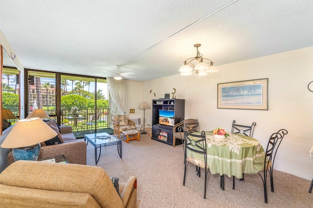 2695 S Kihei Rd Unit 1204, Kihei, HI 96753 - dining space featuring carpet, a chandelier, a textured ceiling, expansive windows, and ceiling fan