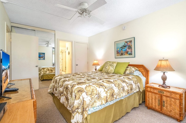 2695 S Kihei Rd Unit 1204, Kihei, HI 96753 - bedroom with light colored carpet, a textured ceiling, and ceiling fan
