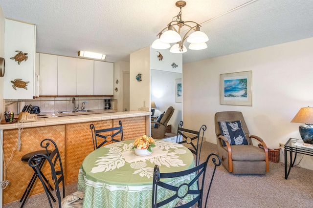 2695 S Kihei Rd Unit 1204, Kihei, HI 96753 - dining room with carpet, a chandelier, and a textured ceiling