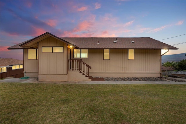 back house at dusk with a yard