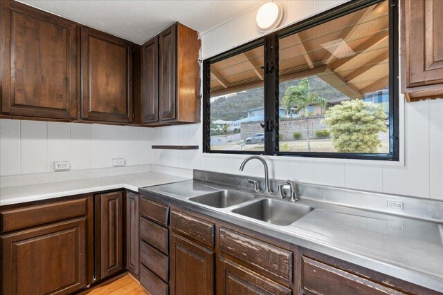 263 S Alu Rd, Wailuku, HI 96793 - kitchen featuring a sink, dark brown cabinets, and light countertops