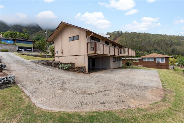 view of property exterior with a wooden deck