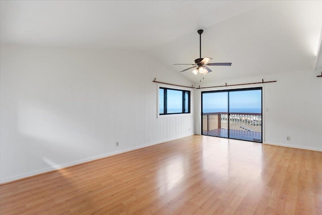 spare room with light wood-type flooring, ceiling fan, and lofted ceiling