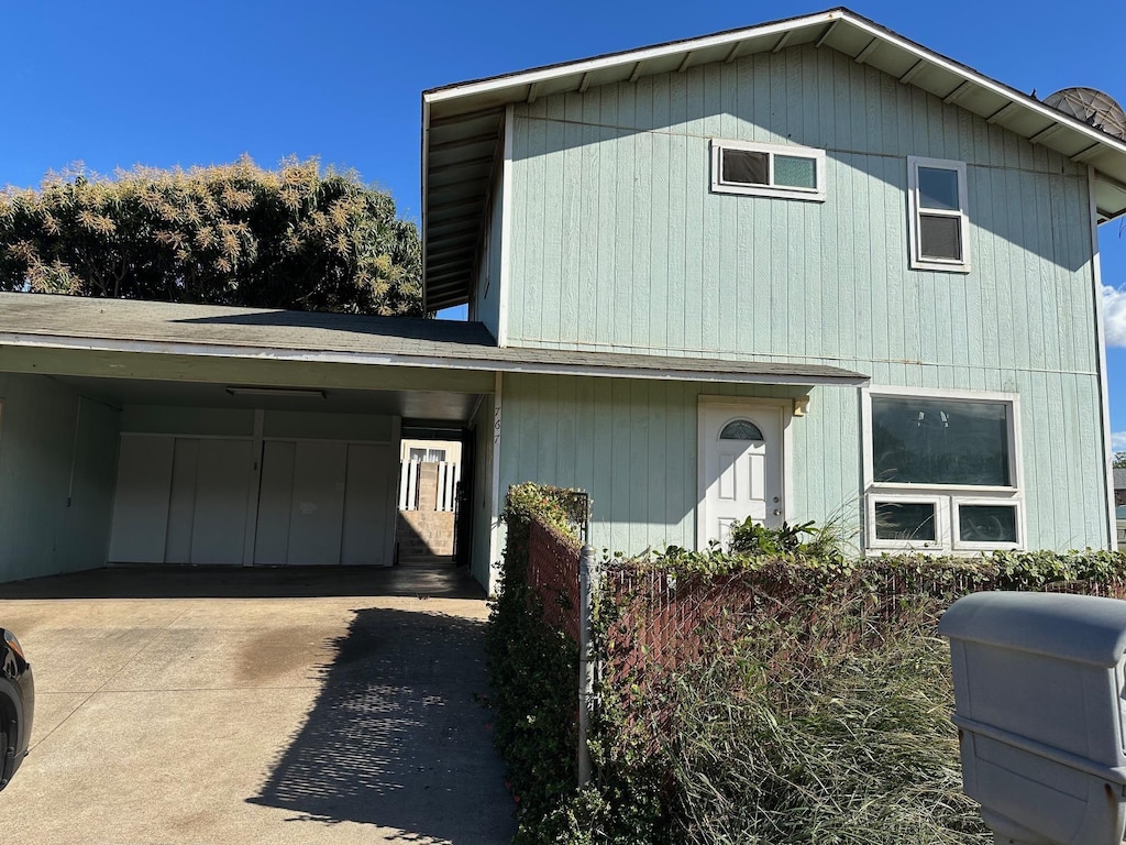 front facade with a carport
