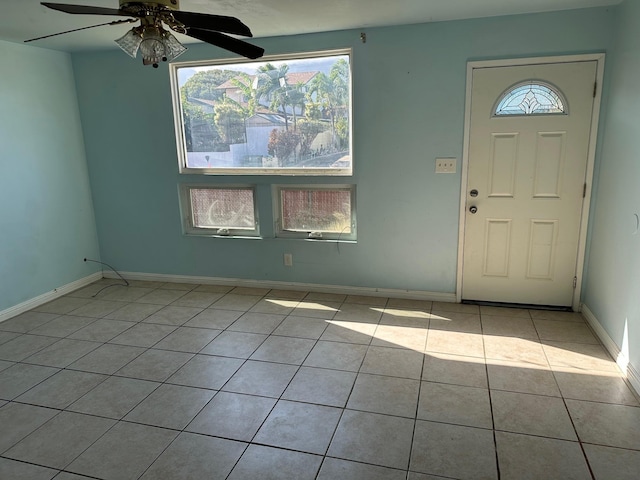 foyer entrance featuring light tile patterned floors and ceiling fan