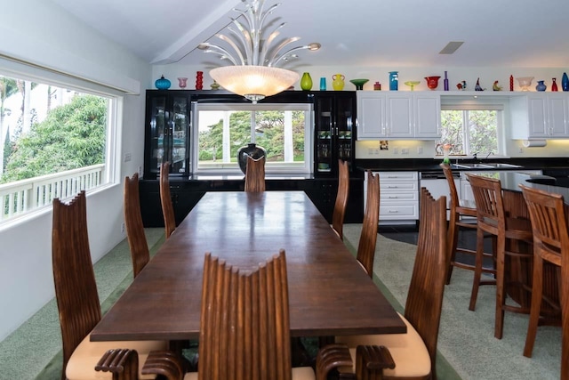 dining area featuring sink and carpet flooring