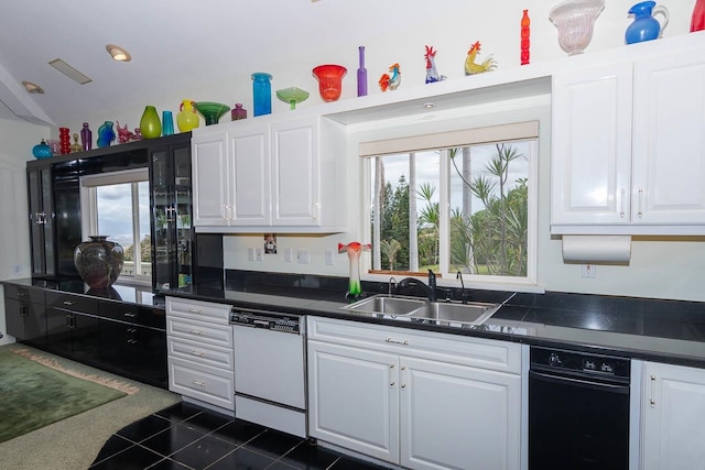 kitchen featuring white cabinets, sink, dark tile flooring, and dishwasher