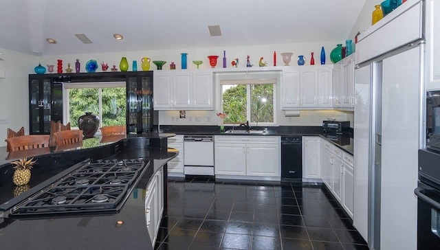 kitchen featuring dark tile floors, white cabinets, black appliances, and sink