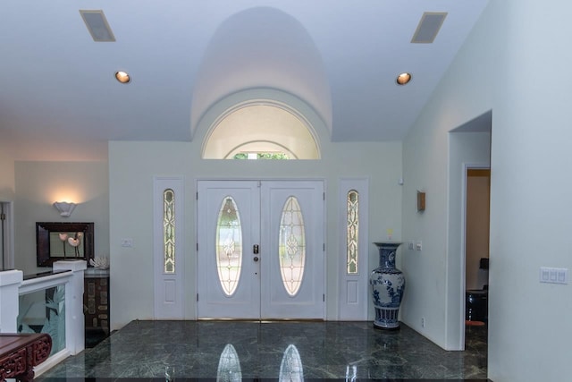 foyer featuring a healthy amount of sunlight, french doors, high vaulted ceiling, and tile floors