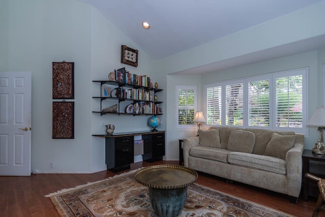 living room with lofted ceiling, hardwood / wood-style flooring, and a wealth of natural light