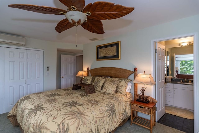 bedroom with sink, ceiling fan, a closet, a wall mounted AC, and dark carpet