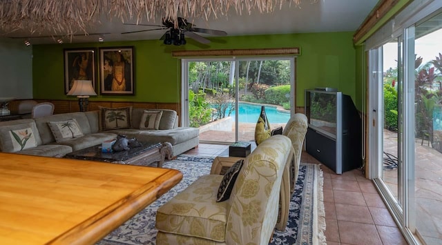 tiled living room featuring ceiling fan